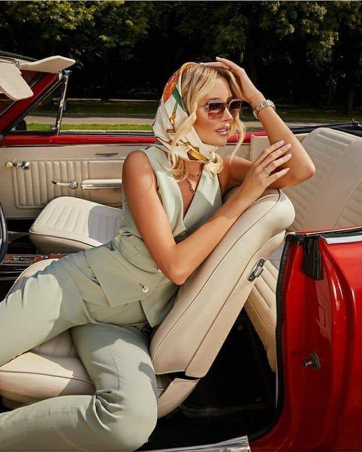 Elegant woman in a luxury car representing refined companionship in Manchester